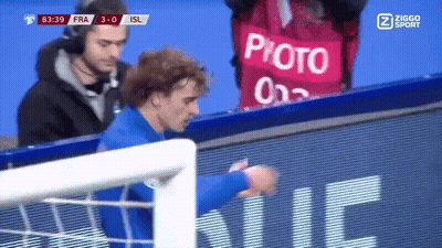A Soccer Player Stands In Front Of A Sign That Says Photo On It GIF