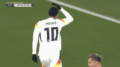 a soccer player stands in front of a sign that says " tig "
