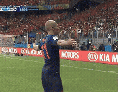 A Soccer Player Stands On A Field With Kia Motors Signs In The Background GIF