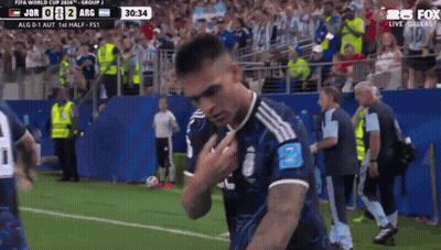 A Soccer Player Stands On The Field In Front Of A Crowd During A Match GIF