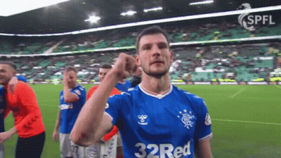 A Soccer Player Wearing A 32 Red Jersey Holds Up His Fist GIF