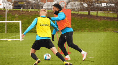 A Soccer Player Wearing A 32Red Vest Kicks A Ball GIF