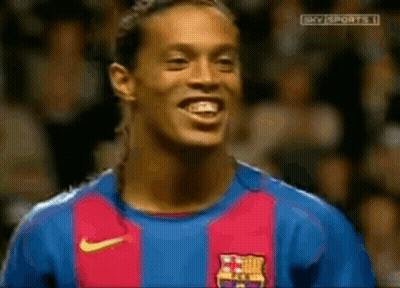 A Soccer Player Wearing A Barcelona Jersey Is Smiling GIF