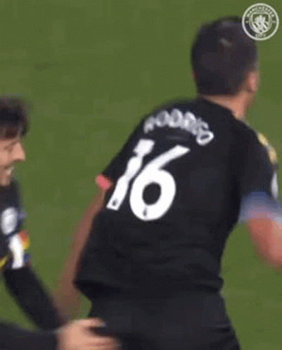 A Soccer Player Wearing A Black And Yellow Shirt With The Word Etihad On The Front GIF