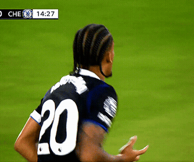 A Soccer Player Wearing A Black Jersey With The Number 20 On The Back GIF