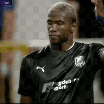 A Soccer Player Wearing A Black Shirt That Says Magdeborg On It GIF