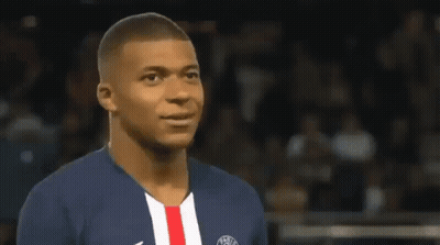 A Soccer Player Wearing A Blue And White Jersey With A Red And White Stripe On The Front Is Smiling . GIF