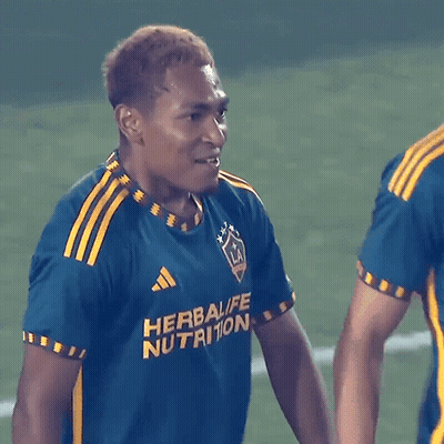 A Soccer Player Wearing A Blue And Yellow Shirt That Says Herbalife Nutrition GIF