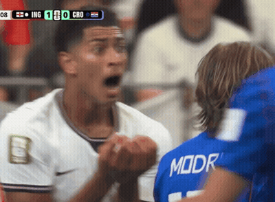 A Soccer Player Wearing A Blue Moor Jersey Stands In Front Of Another Player GIF
