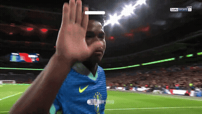 A Soccer Player Wearing A Blue Nike Jersey Is Waving At The Camera GIF