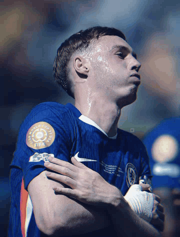 A Soccer Player Wearing A Blue Shirt With A Fifa Logo On It GIF