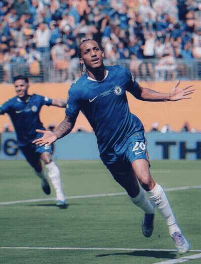 A Soccer Player Wearing A Blue Shirt With The Number 20 On It GIF