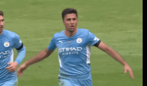 A Soccer Player Wearing A Blue Shirt With The Word Etihad Airways On It Is Running On A Field . GIF