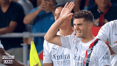 A Soccer Player Wearing A Fly Emirates Jersey High Fives His Teammates GIF