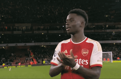 A Soccer Player Wearing A Fly Emirates Jersey Is Clapping GIF