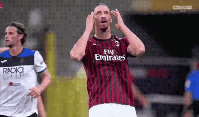 A Soccer Player Wearing A Fly Emirates Jersey Is Making A Funny Face GIF