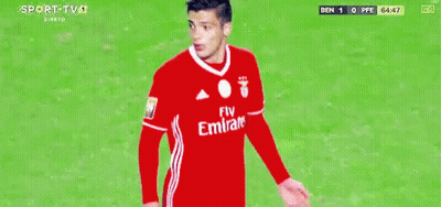 A Soccer Player Wearing A Fly Emirates Jersey Is Standing On A Field GIF
