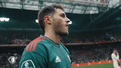 A Soccer Player Wearing A Green Adidas Jersey Is Standing On The Field . GIF