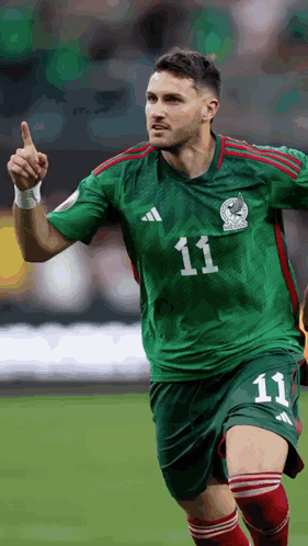 A Soccer Player Wearing A Green And Red Jersey With The Number 11 On It GIF