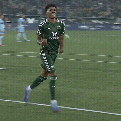 A Soccer Player Wearing A Green And Yellow Jersey With The Letter T On It GIF