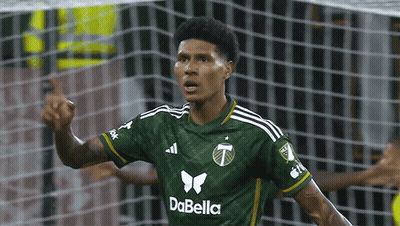 A Soccer Player Wearing A Green Dabella Jersey Celebrates GIF