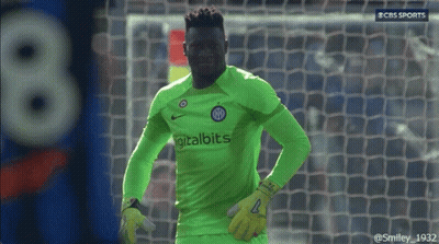 A Soccer Player Wearing A Green Digitalbits Jersey Stands In Front Of A Goal GIF