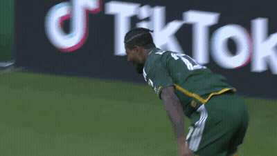 A Soccer Player Wearing A Green Jersey With The Number 11 On It GIF