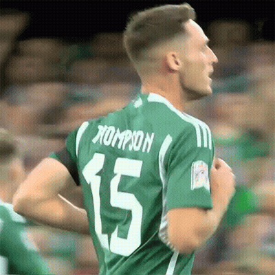 A Soccer Player Wearing A Green Jersey With The Number 15 On The Back GIF