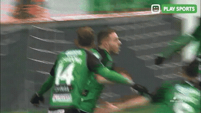 A Soccer Player Wearing A Green Jersey With The Number 4 On It GIF