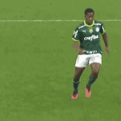 A Soccer Player Wearing A Green Jersey With The Word Caf On It Is Kicking Another Player GIF