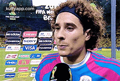A Soccer Player Wearing A Headband Is Talking Into A Microphone On A Soccer Field GIF