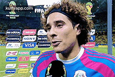 A Soccer Player Wearing A Headband Is Talking Into A Microphone GIF