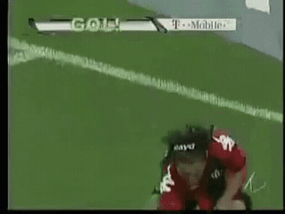A Soccer Player Wearing A Helmet Is Kneeling On The Field With A T-Mobile Ad In The Background GIF