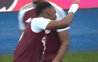 A Soccer Player Wearing A Maroon Jersey With A White Letter G On The Back GIF
