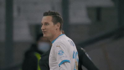 A Soccer Player Wearing A Medina 14 Jersey Stands Next To Another Player GIF