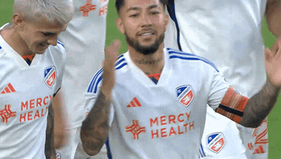 A Soccer Player Wearing A Mercy Health Jersey Celebrates With His Teammates GIF