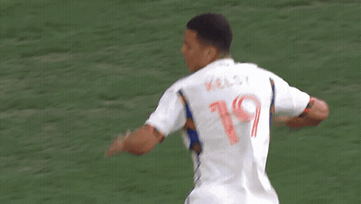 A Soccer Player Wearing A Mercy Health Jersey Is Being Congratulated By His Teammate GIF