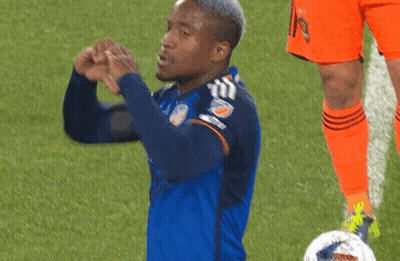 A Soccer Player Wearing A Mercy Health Jersey Makes A Heart Shape With His Hands GIF