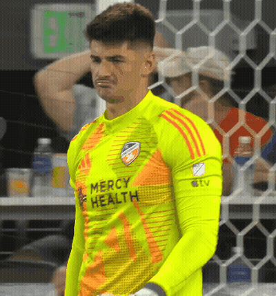 A Soccer Player Wearing A Mercy Health Jersey Stands In Front Of A Net GIF