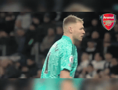 A Soccer Player Wearing A Number 1 Jersey Stands In Front Of An Arsenal Logo GIF