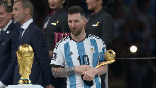 A Soccer Player Wearing A Number 10 Jersey Holds A Trophy GIF