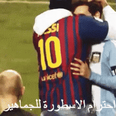 A Soccer Player Wearing A Number 10 Jersey Is Hugging Another Player GIF