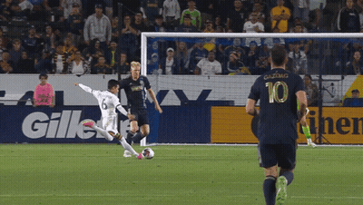 A Soccer Player Wearing A Number 10 Jersey Is Kicking The Ball GIF