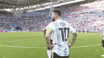 A Soccer Player Wearing A Number 10 Jersey Is Standing On A Soccer Field With His Hands On His Hips . GIF