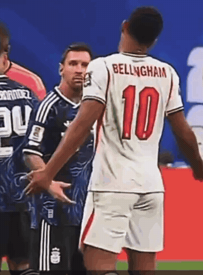A Soccer Player Wearing A Number 10 Jersey Talks To Another Player GIF