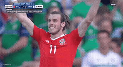 A Soccer Player Wearing A Number 11 Jersey Is Raising His Arms In The Air GIF