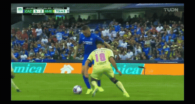 A Soccer Player Wearing A Number 18 Jersey Is Being Tackled GIF