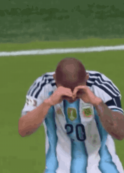 A Soccer Player Wearing A Number 20 Jersey Is Making A Heart Shape With His Hands GIF