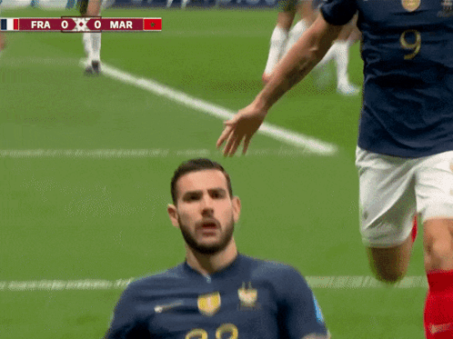 A Soccer Player Wearing A Number 22 Jersey Is Being Tackled By Another Player GIF