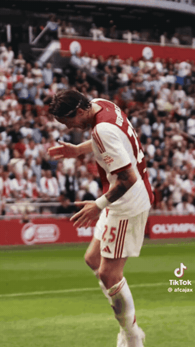 A Soccer Player Wearing A Number 25 Jersey Is Jumping In The Air GIF